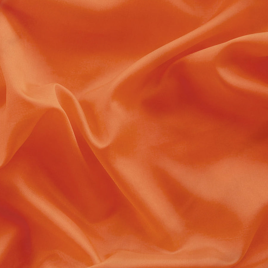 close up of the satin material used to make Evolve's satin Sunset bonnet